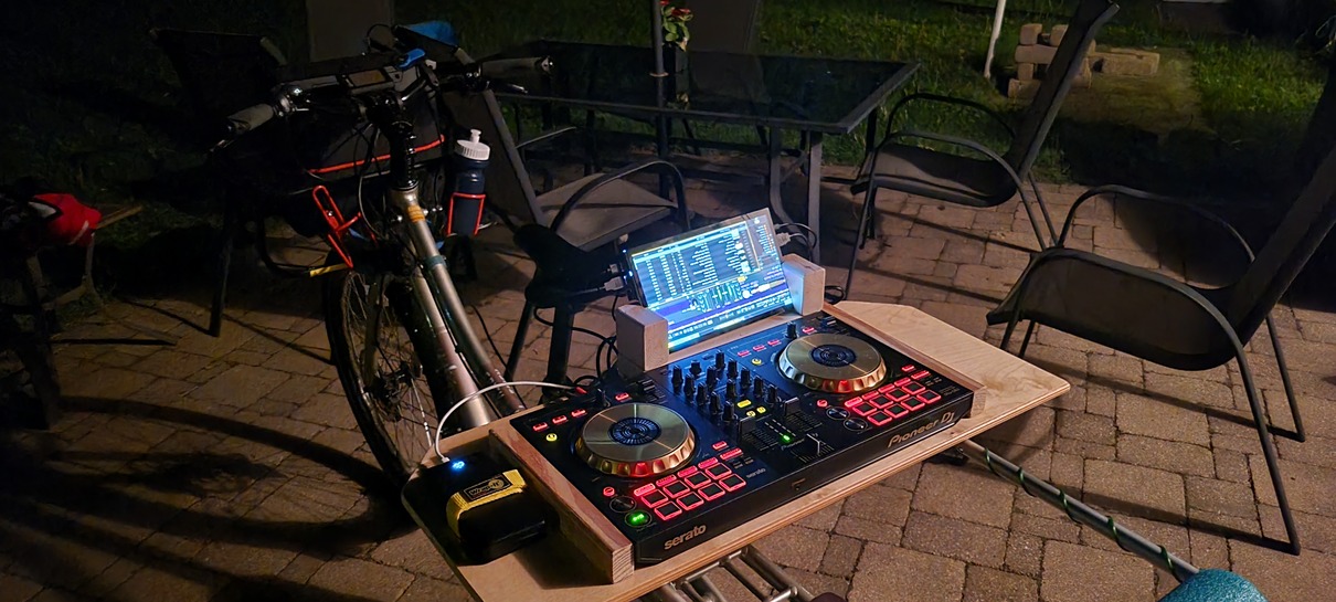 dj controller, touchscreen display on a wood tray on the back of a cargo bicycle